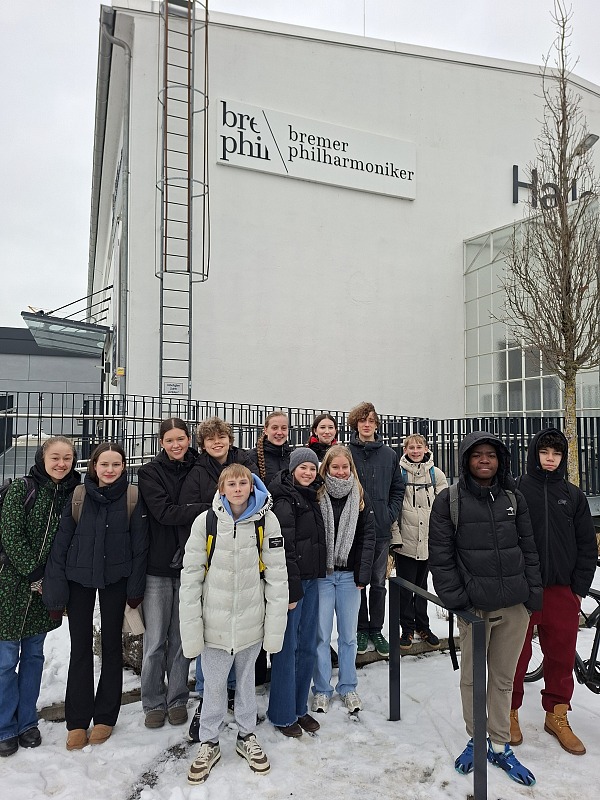 Schüler:innen, die bei der BigBand spielen vor dem Gebäude der Bremer Philharmoniker